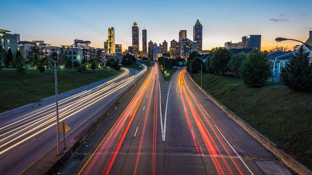 Traffic lights blurred with the Atlanta skyline in the background. There is an abundance of customers in your market -- divert that traffic to your website with effective SEO.