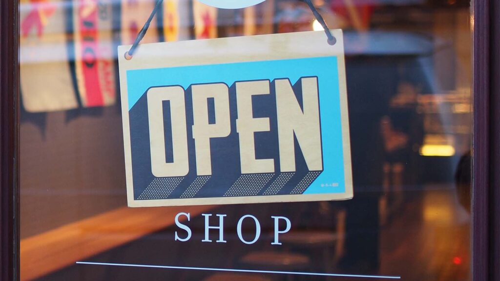 Open sign on a shop -- unlike e-commerce stores that are open 24/7