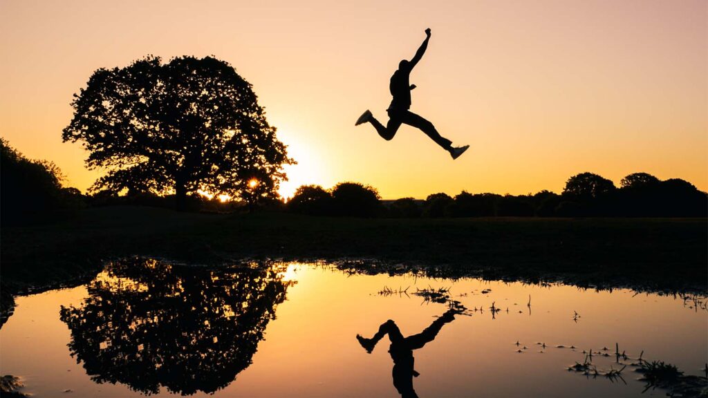 A man leaps over water in silhouette. Make sure the call to action on your page is clear and unmistakable -- what action do you want the user to take?