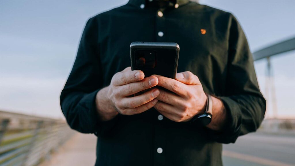 A smartphone user navigates on his phone -optimizing your site for mobile is one of the easiest and smartest strategies a business can use to reach their customer